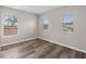 Cozy bedroom featuring plank flooring, three bright windows, and neutral walls at 634 Canna Dr, Davenport, FL 33897