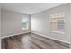 Well-lit bedroom with plank flooring and two large windows offering natural light at 634 Canna Dr, Davenport, FL 33897