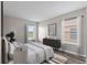 Bright bedroom with modern furnishings, natural light, and wood-look floors at 634 Canna Dr, Davenport, FL 33897