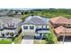 Beautiful two-story home featuring a front-entry two-car garage and scenic backyard pond view at 634 Canna Dr, Davenport, FL 33897