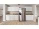 Kitchen with stainless steel refrigerator and white cabinets, tile flooring and granite countertops at 634 Canna Dr, Davenport, FL 33897