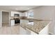 Bright kitchen features stainless steel appliances, granite countertops, and white cabinetry at 634 Canna Dr, Davenport, FL 33897