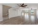 Open-concept living room featuring wood-look flooring, two ceiling fans and lots of natural light at 634 Canna Dr, Davenport, FL 33897