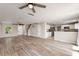Open-concept living space with hardwood floors, kitchen access, and natural light at 634 Canna Dr, Davenport, FL 33897