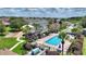 Community pool and playground area with lounge chairs, palm trees, and well-maintained landscaping at 634 Canna Dr, Davenport, FL 33897