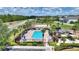 Community pool featuring lounge chairs, sun umbrellas, and lush, tropical landscaping at 634 Canna Dr, Davenport, FL 33897