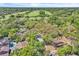 Aerial view showcasing golf course close to homes in lush, green community at 130 Stag Ridge Ct, Longwood, FL 32779
