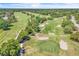 Aerial view of a lush green golf course with pristine fairways and strategically placed sand traps at 130 Stag Ridge Ct, Longwood, FL 32779