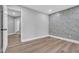 Cozy bedroom with modern accent wall and wood-look flooring at 130 Stag Ridge Ct, Longwood, FL 32779