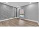 Cozy bedroom with modern accent wall and bright window at 130 Stag Ridge Ct, Longwood, FL 32779