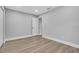 Bright bedroom with wood-look floors and neutral walls and a door at 130 Stag Ridge Ct, Longwood, FL 32779