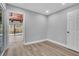 Cozy bedroom with light gray walls, wood-look floors, and backyard access through sliding doors at 130 Stag Ridge Ct, Longwood, FL 32779