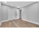 Spacious bedroom with wood floor, white walls, a closet, and a door at 130 Stag Ridge Ct, Longwood, FL 32779