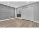 Bedroom featuring wood-look floors, a gray accent wall, and a closet at 130 Stag Ridge Ct, Longwood, FL 32779