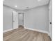 Neutral bedroom featuring light gray walls, wood-look floors, and a closet with a white door at 130 Stag Ridge Ct, Longwood, FL 32779