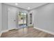 Bright bedroom with wood floors, direct backyard access, and neutral tones at 130 Stag Ridge Ct, Longwood, FL 32779