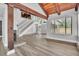 Bright, open living space with wooden beams, fireplace, and staircase to the second floor at 130 Stag Ridge Ct, Longwood, FL 32779