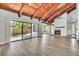 Spacious living room featuring wood ceiling, flooring, fireplace, and natural light from sliding glass doors at 130 Stag Ridge Ct, Longwood, FL 32779