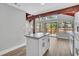 Bright, open-concept space with wooden beams connecting kitchen and dining with backyard views at 130 Stag Ridge Ct, Longwood, FL 32779