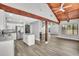 Open concept living area with wooden beams, modern kitchen, and a seamless flow for entertaining at 130 Stag Ridge Ct, Longwood, FL 32779