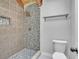 Close up of tile shower with gray accents and shower head at 130 Stag Ridge Ct, Longwood, FL 32779