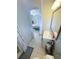 Bright bathroom with white vanity and tiled floor, adjacent to a bedroom at 201 Lake Bonny E Dr, Lakeland, FL 33801