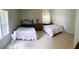 Bedroom with two beds, overhead lighting and side table at 201 Lake Bonny E Dr, Lakeland, FL 33801