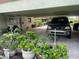 Carport with plants, parked car, and various stored items at 201 Lake Bonny E Dr, Lakeland, FL 33801