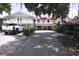 Charming exterior of a multi-story home with well-maintained landscaping and a long driveway leading to ample parking at 201 Lake Bonny E Dr, Lakeland, FL 33801