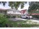 Scenic exterior of a home featuring lush greenery, a well-manicured lawn, and ample parking at 201 Lake Bonny E Dr, Lakeland, FL 33801