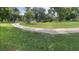 Expansive front yard showcasing a winding driveway and lush green grass, enhancing curb appeal at 201 Lake Bonny E Dr, Lakeland, FL 33801
