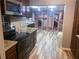 Open kitchen with modern appliances and views to the dining room and laundry area at 201 Lake Bonny E Dr, Lakeland, FL 33801