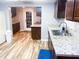 Well-maintained kitchen features granite countertops, stainless steel sink, and wood-look flooring at 201 Lake Bonny E Dr, Lakeland, FL 33801