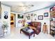 Inviting living room with tiled floors, a brown leather sofa, and a doorway leading to the bedroom at 201 Lake Bonny E Dr, Lakeland, FL 33801