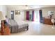 Spacious main bedroom with tiled floor, closet, and french doors at 201 Lake Bonny E Dr, Lakeland, FL 33801