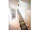 Carpeted staircase with white banister and railing and a window at the landing at 201 Lake Bonny E Dr, Lakeland, FL 33801