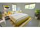 Bright bedroom features a yellow bed, accent rug, and multiple windows at 3632 Mockingbird Ln, Orlando, FL 32803