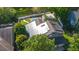 Aerial view of a home with solar panels, a backyard pool, and lush green landscaping at 1315 Olympia Park Cir, Ocoee, FL 34761