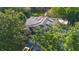 Aerial view of a home with solar panels, mature trees, and a yellow truck in the driveway at 1315 Olympia Park Cir, Ocoee, FL 34761