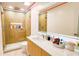 Bathroom featuring a glass shower, vanity, and a lighted mirror at 1315 Olympia Park Cir, Ocoee, FL 34761