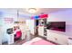 Bedroom with a closet and a desk with shelving units and led lights at 1315 Olympia Park Cir, Ocoee, FL 34761