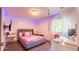Charming bedroom featuring a gray bed frame, desk and blue LED strip lighting at 1315 Olympia Park Cir, Ocoee, FL 34761
