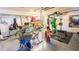 View of the garage with exercise equipment, bicycles, and various stored items throughout the room at 1315 Olympia Park Cir, Ocoee, FL 34761