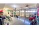 Spacious garage with epoxy floor, multiple garage doors, and exercise equipment against the back wall at 1315 Olympia Park Cir, Ocoee, FL 34761