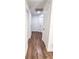 Hallway featuring wood laminate flooring, white walls, white doors and neutral paint at 1315 Olympia Park Cir, Ocoee, FL 34761