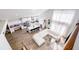 Open-concept living space, showcasing kitchen and white sectional sofa, with floor to ceiling windows at 1315 Olympia Park Cir, Ocoee, FL 34761