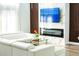 Contemporary living room with fireplace and sleek white sectional at 1315 Olympia Park Cir, Ocoee, FL 34761