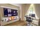 Cozy living room featuring a large TV and a work desk with a view at 1315 Olympia Park Cir, Ocoee, FL 34761