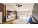 Well-lit primary bedroom featuring a large TV, accent wall, and backyard access at 1315 Olympia Park Cir, Ocoee, FL 34761