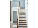 Staircase featuring wood and white painted stairs, wooden railing and white risers at 1315 Olympia Park Cir, Ocoee, FL 34761
